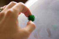 Décorer des ballons de baudruche avec des pompons