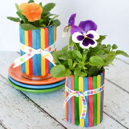 Des pots à fleurs en bâtonnets de glace colorés à partir de boîtes de conserve pour maman qui a la main verte
