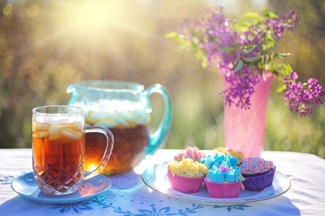 Thé glacé et petits gâteaux sur une table dans le jardin