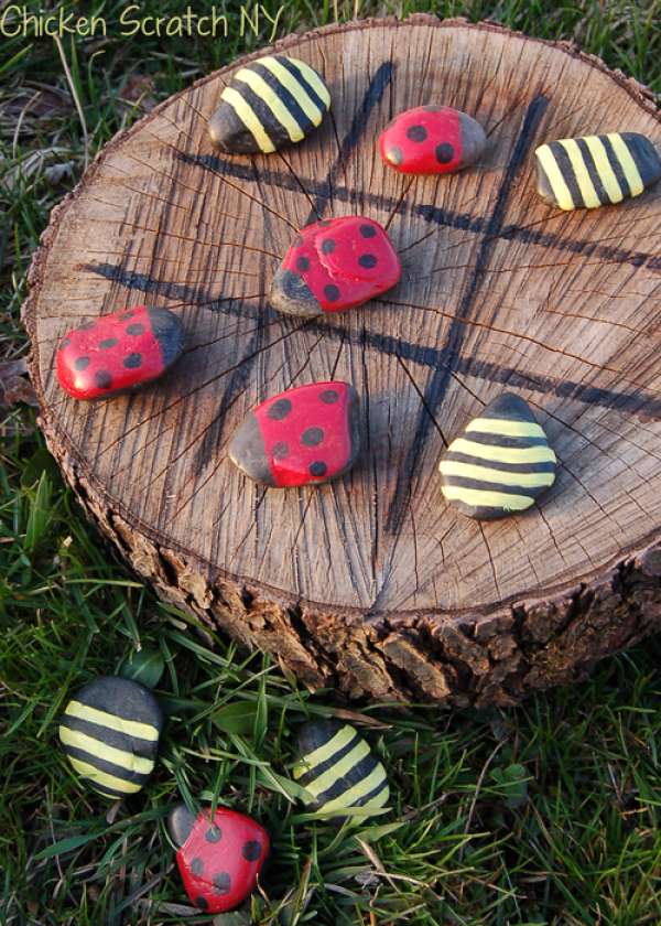 Tic-tac-toe ou morpion avec une rondelle de bois et des pierres peintes