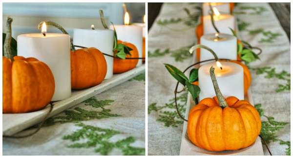 Un centre de table avec des mini citrouilles et des bougies