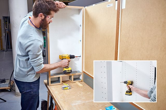 Fixation d'une cloison latérale à l'arrière des caissons de cuisine.