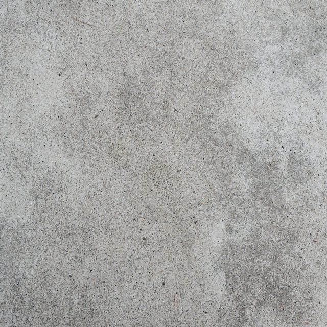 Une dalle de béton gris clair, lisse et texturée.