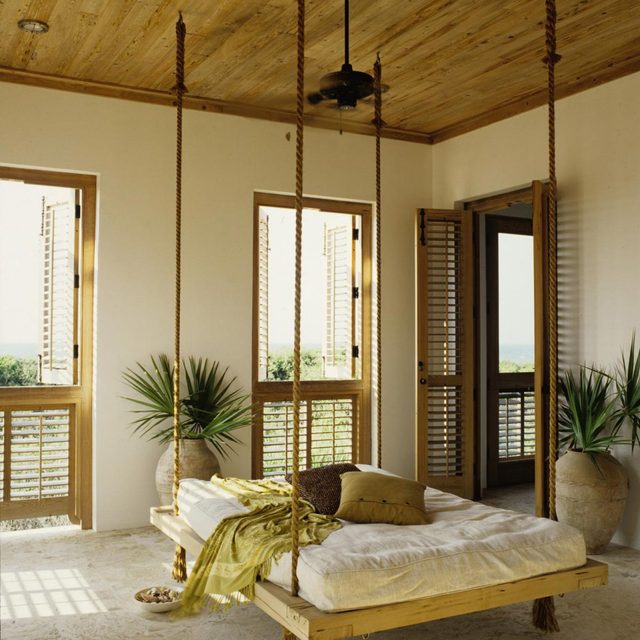 Un lit suspendu se balance doucement dans une pièce avec des fenêtres ouvertes donnant sur la verdure.