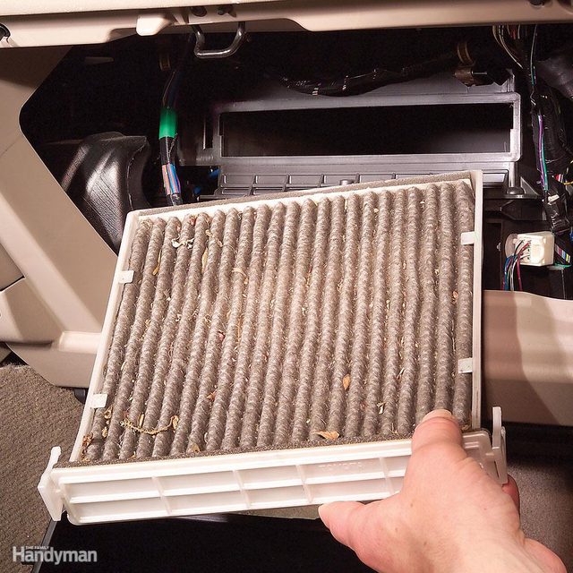 Un filtre d'habitacle de voiture très sale à côté d'un neuf.