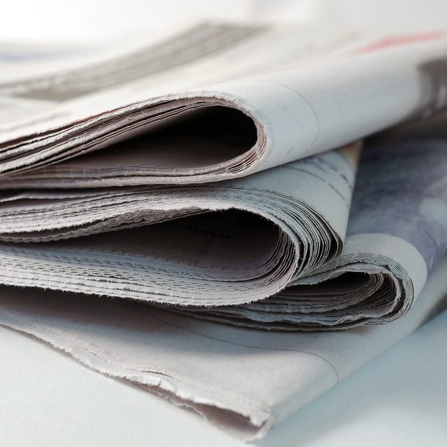 Une pile de vieux journaux pliés.